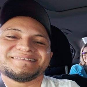 Your HonduDrivers driver smiling behind the wheel with guests in the back seat